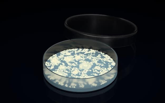 A glowing bacterial culture in a petri dish emitting blue light, labeled with 