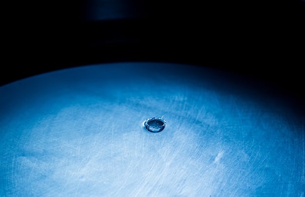 A high-resolution image of a deeply shadowed crater interior on the Moon's far side, with subtle blue hues indicating the presence of water ice, observed by an orbiting spacecraft.