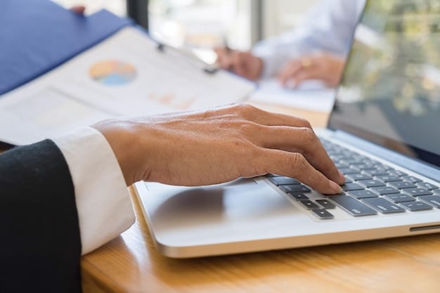A close-up of hands typing on a computer, symbolizing job searching and the digital economy. The image suggests both opportunities and challenges faced by workers in today's labor market, related to Analyzing the Latest US Unemployment Rate and its impact.