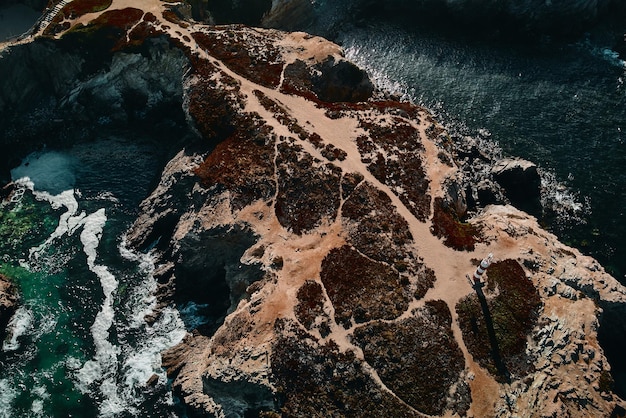 A satellite image showing areas of significant coastal erosion along a coastline in the United States. The image highlights how erosion is impacting critical habitats and infrastructure, and it underscores the US Climate Change Report: What Are the Projected Impacts on Coastal Regions?.