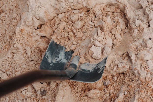 A split-screen image showing traditional archaeological methods on one side (e.g., manual digging and sifting) and AI-powered analysis on the other (e.g., a computer screen displaying an AI algorithm identifying artifacts). The image illustrates the contrast and integration of traditional and modern techniques in the context of The Future of Archaeology: How Drones and AI Are Transforming the Search for Ancient Sites in the US.