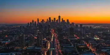 Aerial view of a vibrant American city skyline at dusk, representing population growth.
